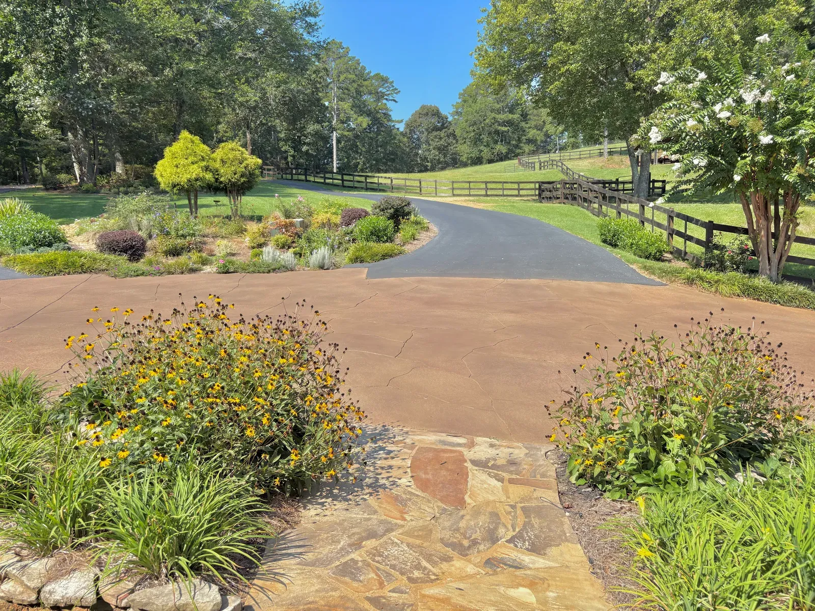 Terracotta stained concrete driveway and flagstone walkway by JP Concrete Creations in Georgia