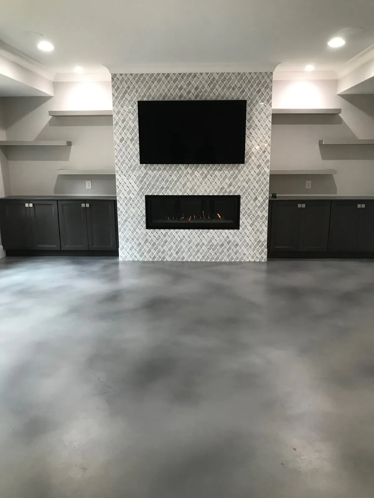 Stained interior concrete floor in a finished living room by JP Concrete Creations