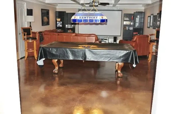 Warm brown acid stained concrete floor in a metro Atlanta game room with a pool table