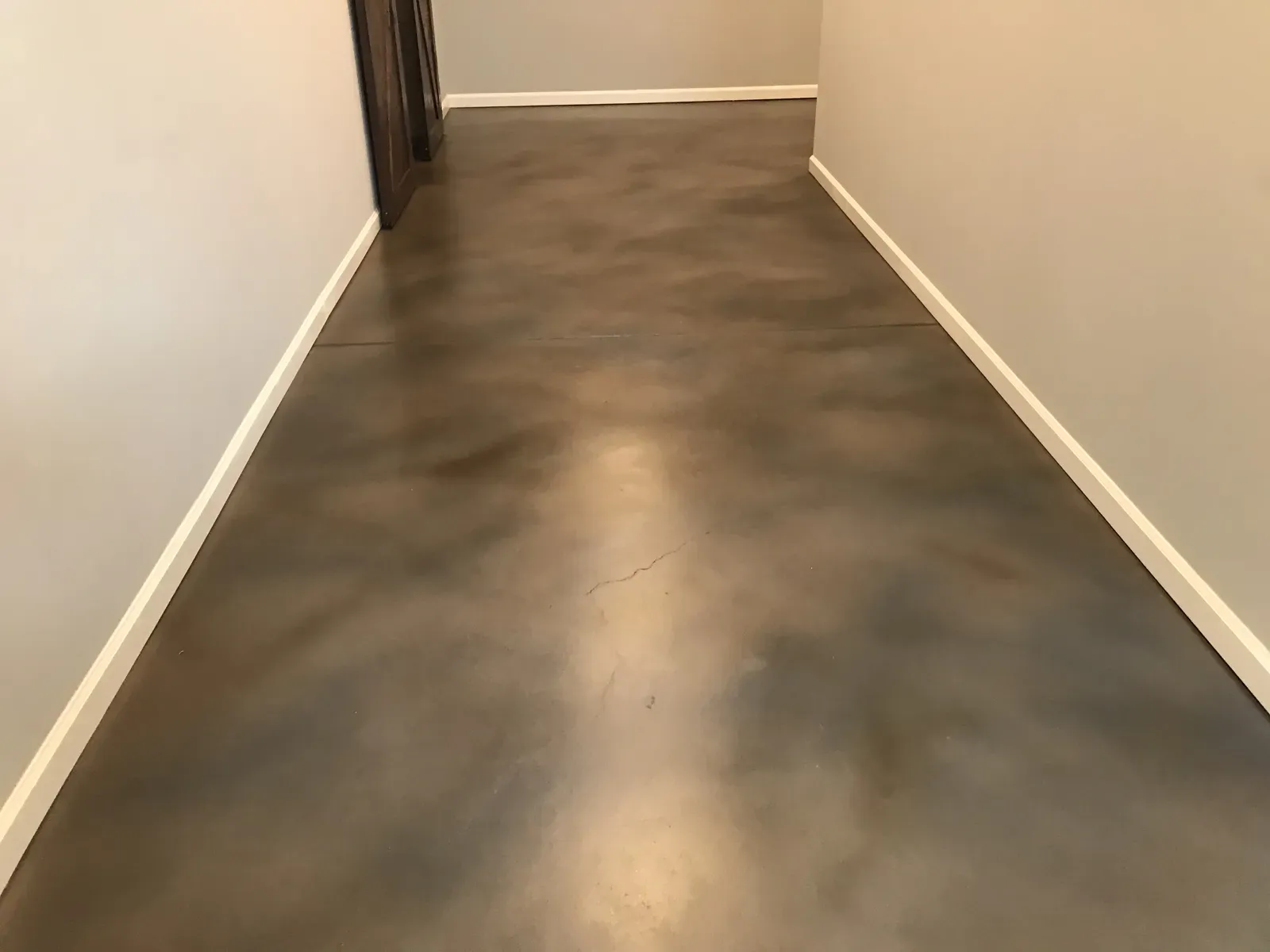 Soft gray stained concrete hallway floor in a Sandy Springs GA home